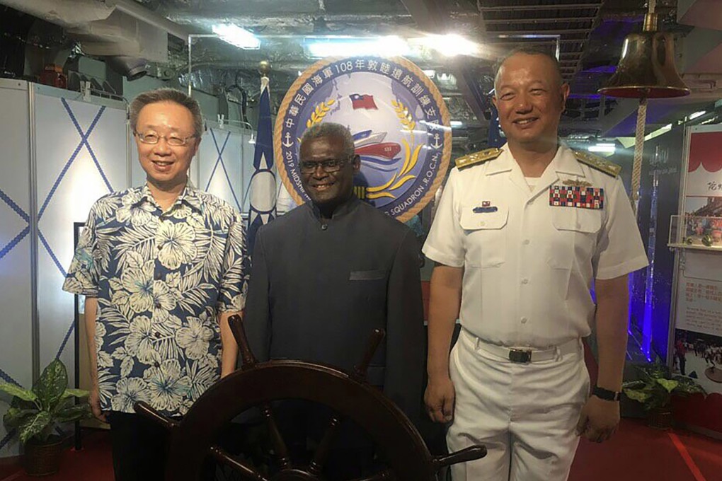 Manasseh Sogavare, prime minister of Solomon Islands (centre), joins Taiwan’s ambassador to the Pacific nation Roger Luo (left) and Commander Rear-Admiral Wang Cheng-chung aboard a Taiwanese naval vessel. Photo: CNA