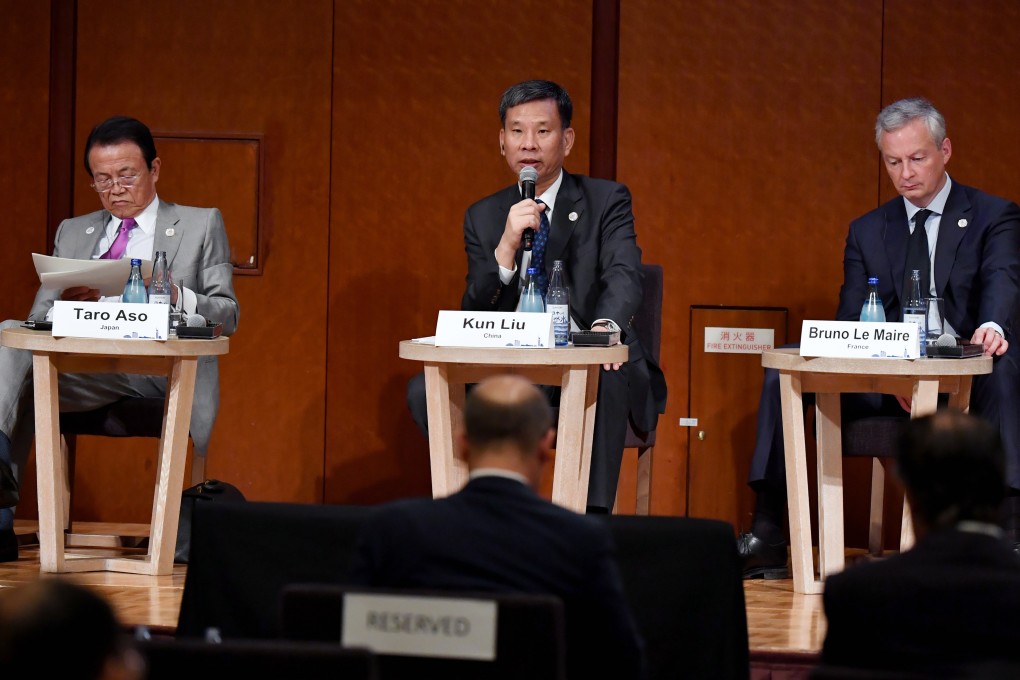 Chinese Finance Minister Liu Kun (centre) delivers a speech at the symposium, flanked by Japanese and French counterparts Taro Aso and Bruno Le Maire. Photo: EPA-EFE