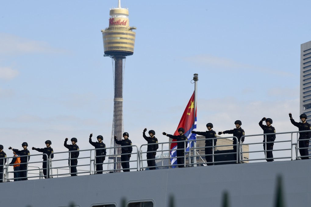 Chinese sailors wave from a PLA Navy ship after it arrives at Garden Island Naval Base in Sydney. Photo: EPA
