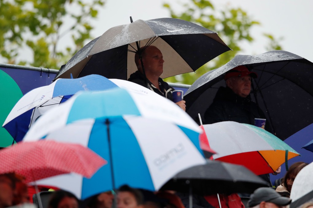 People take shelter as rain stops play at the Cricket World Cup. Photo: Reuters