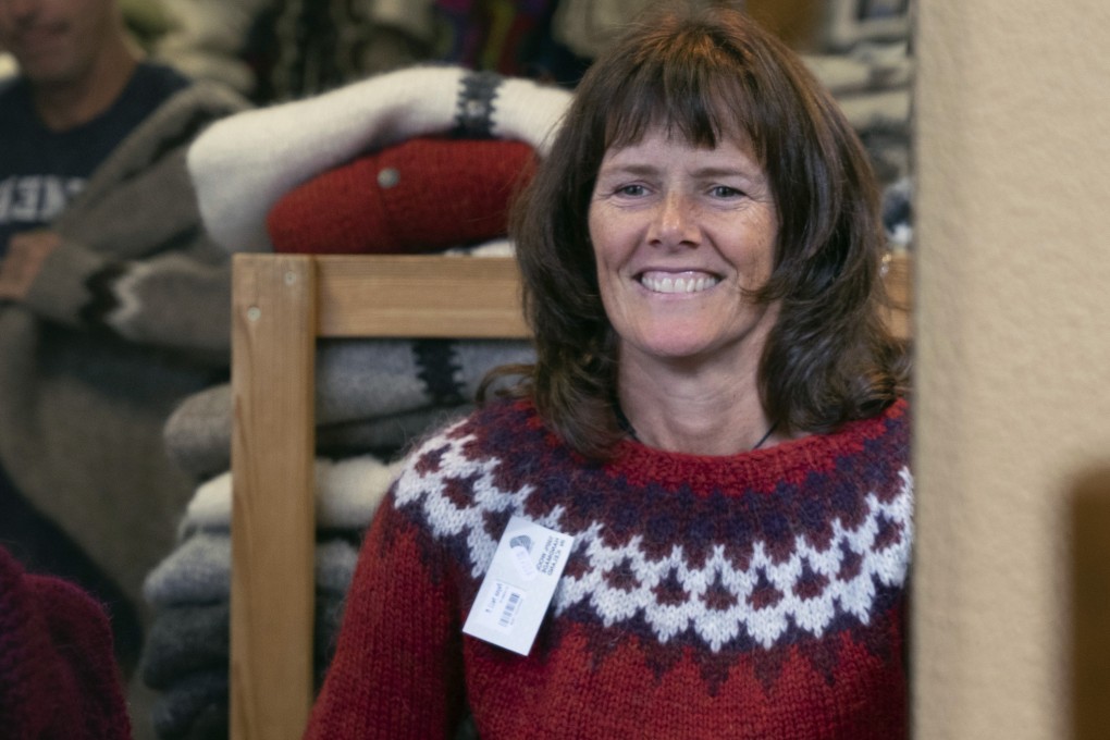 An American tourist tries on an Icelandic “lopi” jmper at a shop in Reykjavik. Photo: AP
