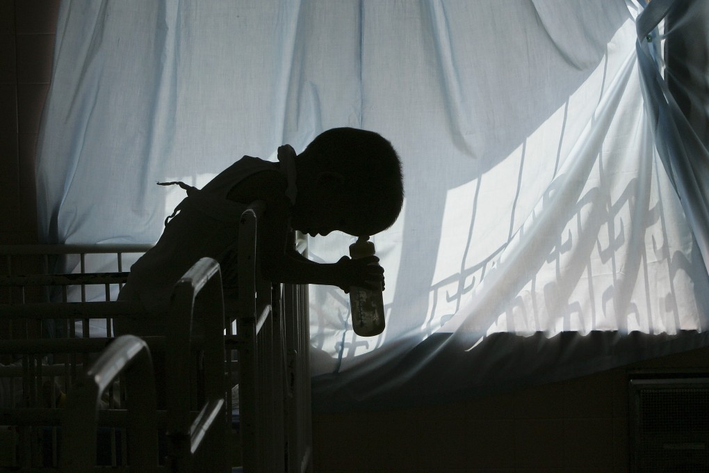A five-year-old disabled victim of Agent Orange rests on his cot in a Ho Chi Minh City hospital in 2005. Photo: Reuters