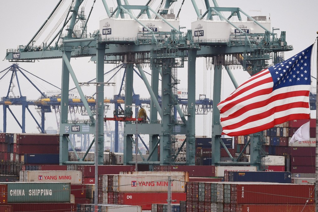 Chinese shipping containers are stored beside a US flag after they were unloaded at the Port of Los Angeles in Long Beach, California. Photo: AFP