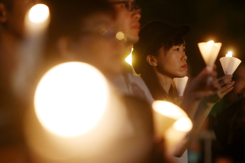 Those gathered hold up their candles in memory of the victims of the Tiananmen Square crackdown, on the 30th anniversary of the June 4 vigil in Victoria Park, Causeway Bay. Photo: Winson Wong