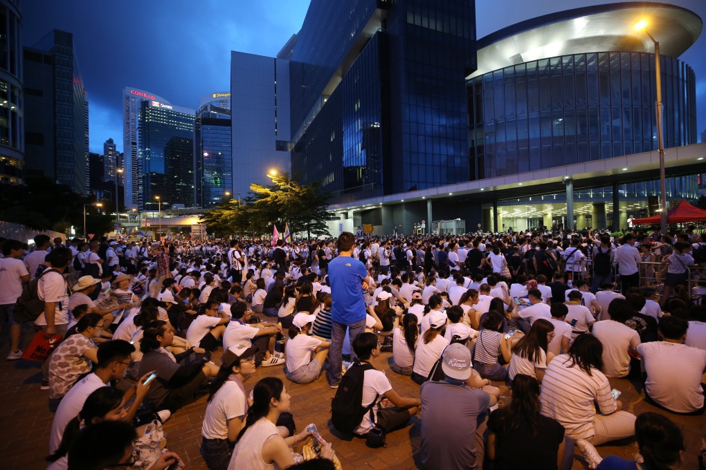 Protesters sit outside government headquarters in Admiralty after Sunday’s march. Photo: Winson Wong