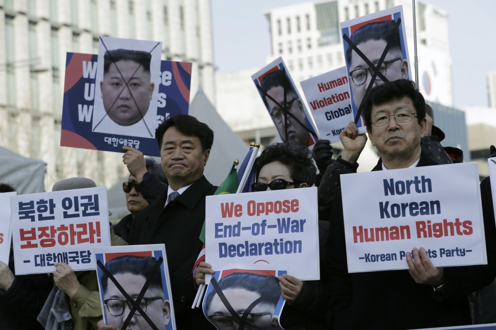 South Korean protesters and North Korean defectors hold portraits of North Korean leader Kim Jong-un during a rally near the US embassy in Seoul in February. Photo: AP