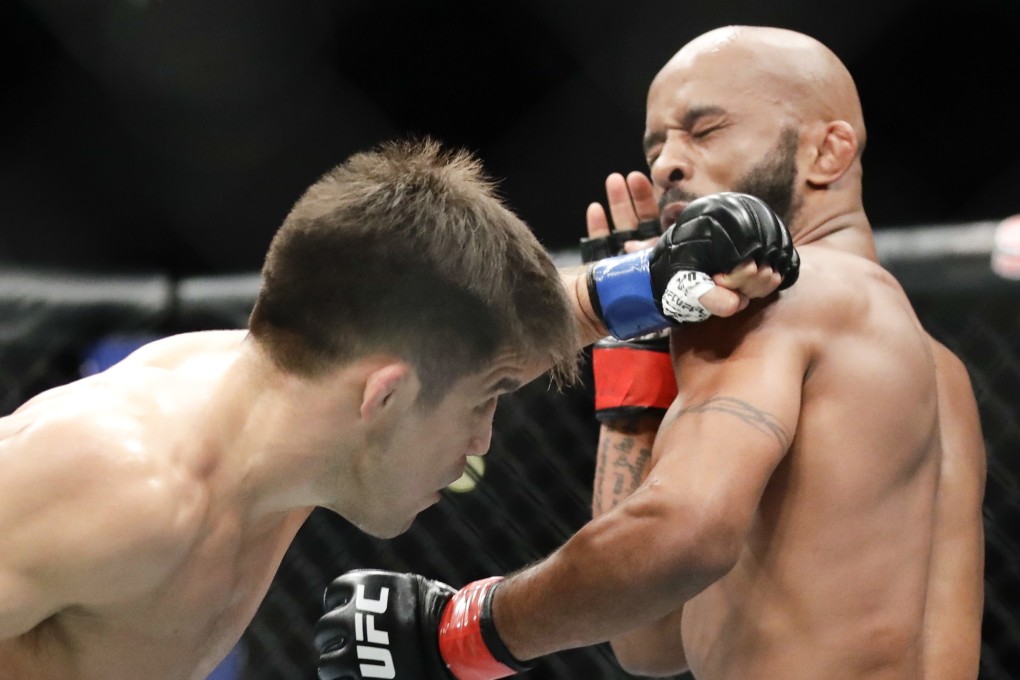Henry Cejudo hits Demetrious Johnson during their UFC flyweight title at UFC 227 in Los Angeles in August 2018. Photo: AP