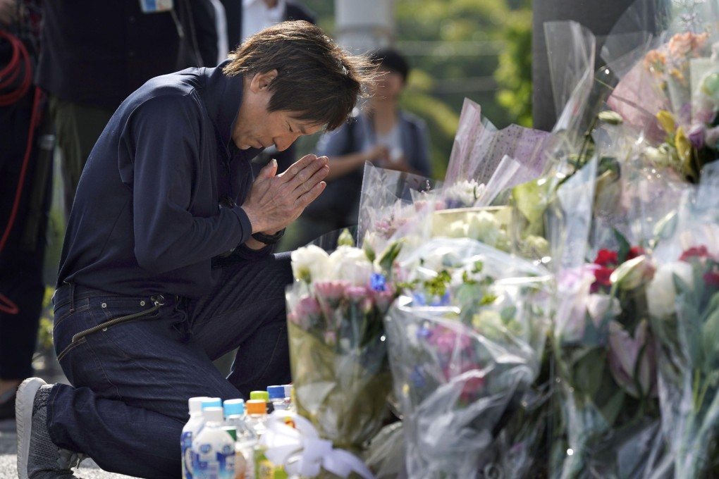 A man prays at the site of a mass stabbing in Kawasaki, near Tokyo, on June 4. Photo: Kyodo