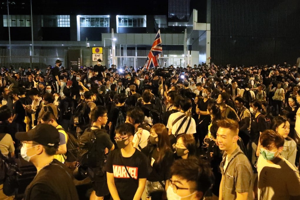 Hundreds gather outside the Legco building in Tamar after it issued an amber security alert. Photo: Dickson Lee