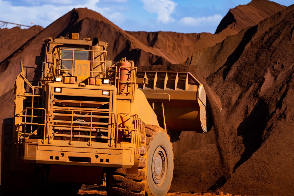Excavators move iron ore in Port Hedland, Australia, in March. Photo: Bloomberg