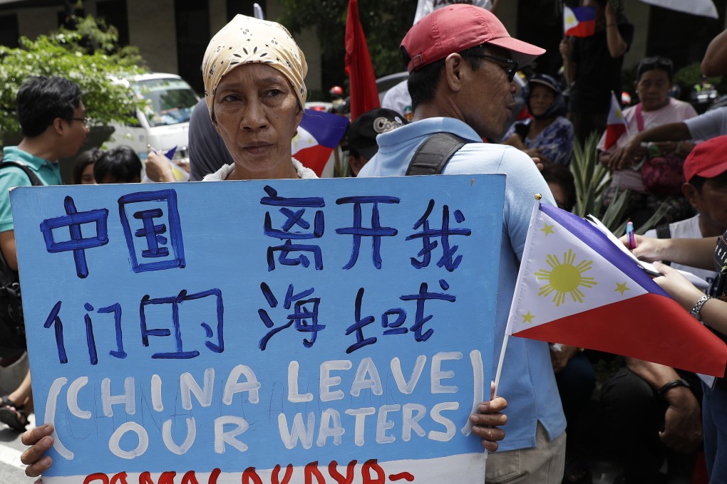 A protester outside the Chinese consulate in Manila calls for China to leave Philippine waters. Photo: AP