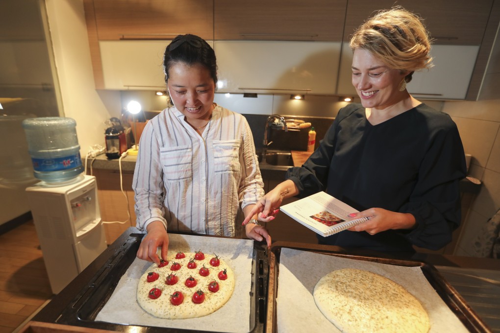 Beijing expat Lise Floris with her ayi Zhang Ting as she cooks focaccia ai pomodorini, or focaccia made with potatoes and cherry tomatoes – a special Italian dish. Photo: Simon Song