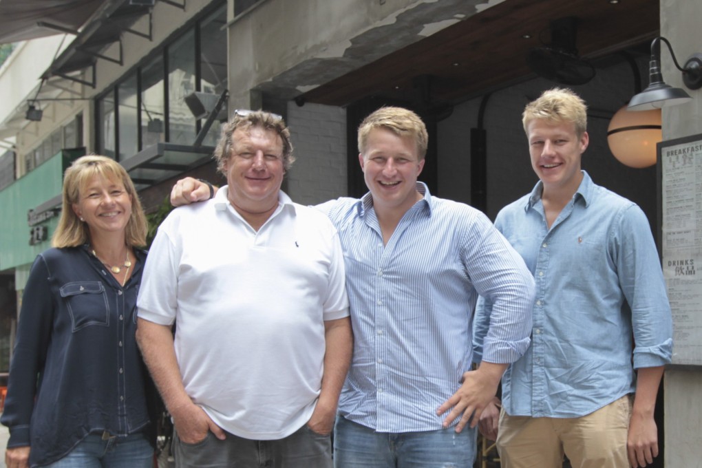 Wayne Parfitt with wife Andrea and sons Jack (second from right) and Michael outside High Street Grill in Sai Ying Pun, one of some 90 restaurants the family’s Castelo Concepts group runs in Hong Kong and Vietnam. Parfitt has died after losing a battle with cancer. Photo: Bruce Yan