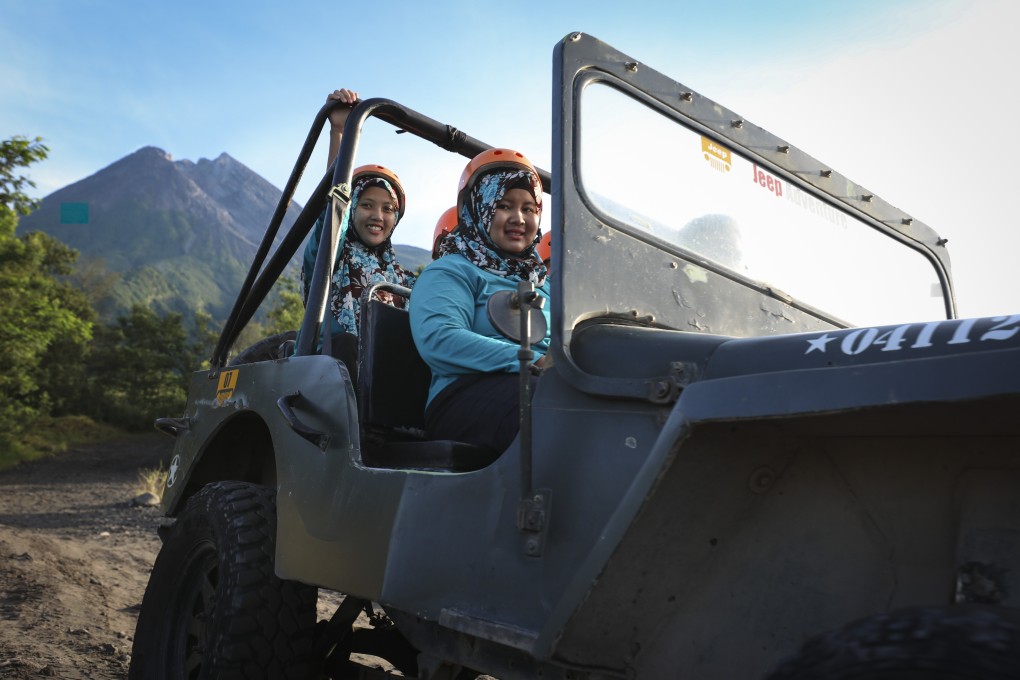 Visitors enjoy a lava tour on Mount Merapi, Indonesia. Nine years after an eruption killed more than 350 people and destroyed three villages, disaster tourism is thriving on its slopes. Photo: James Wendlinger