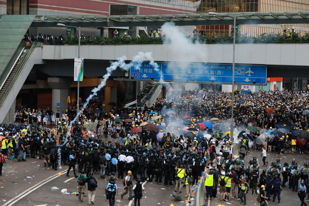 Riot police use tear gas against anti-extradition bill protesters on Harcourt Road in Admiralty on Wednesday. Photo: May Tse