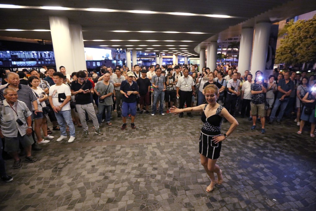 A street performer near in Tsim Sha Tsui draws a motley crowd, including seniors. Photo: Felix Wong