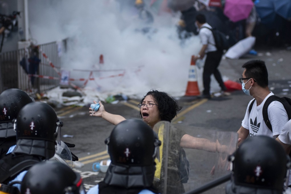 A protester berates police during a demonstration against the proposed extradition law in Hong Kong on Thursday. Photo: DPA