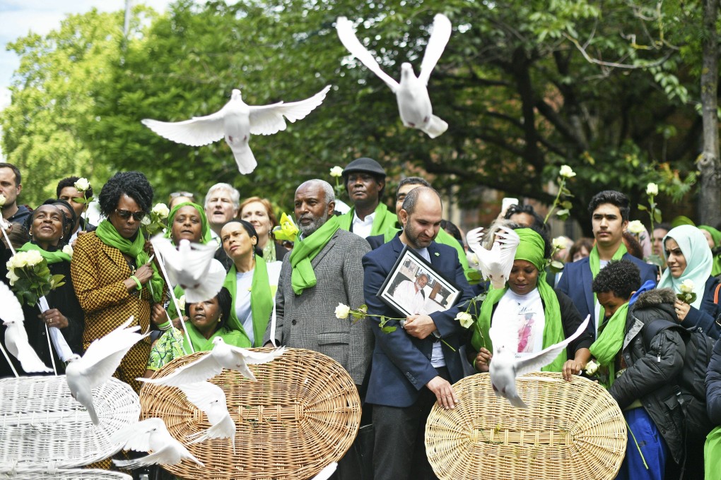Doves are released outside St Helens church in London on Friday after a service to mark the two-year anniversary of the Grenfell Tower block fire. Photo: PA via AP