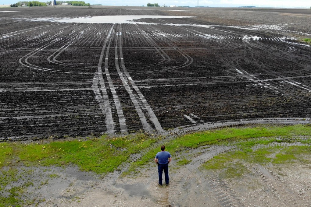 Bill Gordon, of Worthington, Minnesota, views his washed-out farmland. Photo: Xinyan Yu