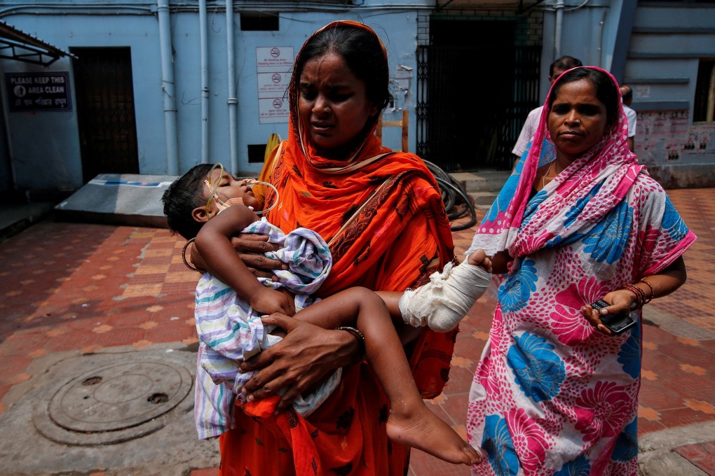 A woman carries her daughter for treatment at a government hospital during Friday’s strike. Photo: Reuters