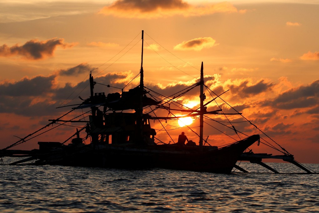 A Philippine boat fishes during sunset at the disputed Scarborough Shoal in April 2017. Photo: Reuters
