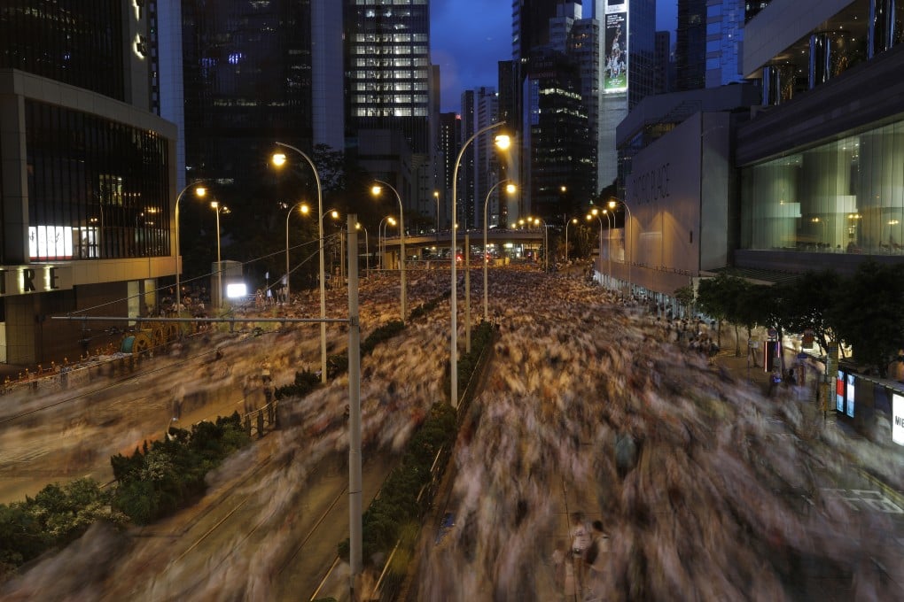 Protesters in Hong Kong march on June 9 against the government’s proposed amendments to an extradition law. Photo: AP