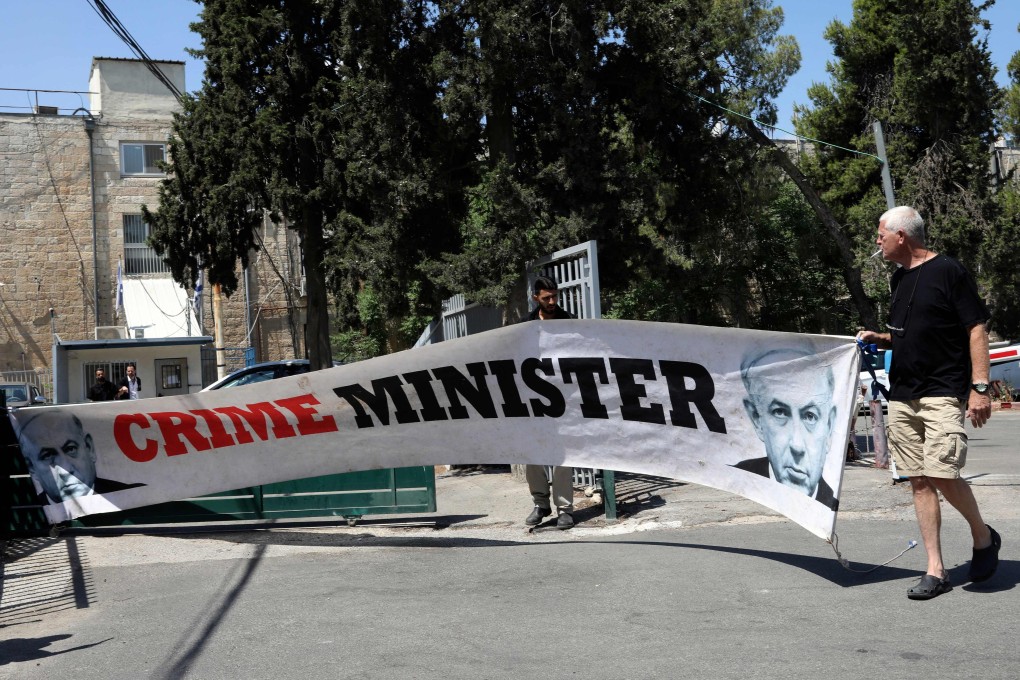 An Israeli man protesting outside the magistrates’ court in Jerusalem on Sunday. Photo: AFP