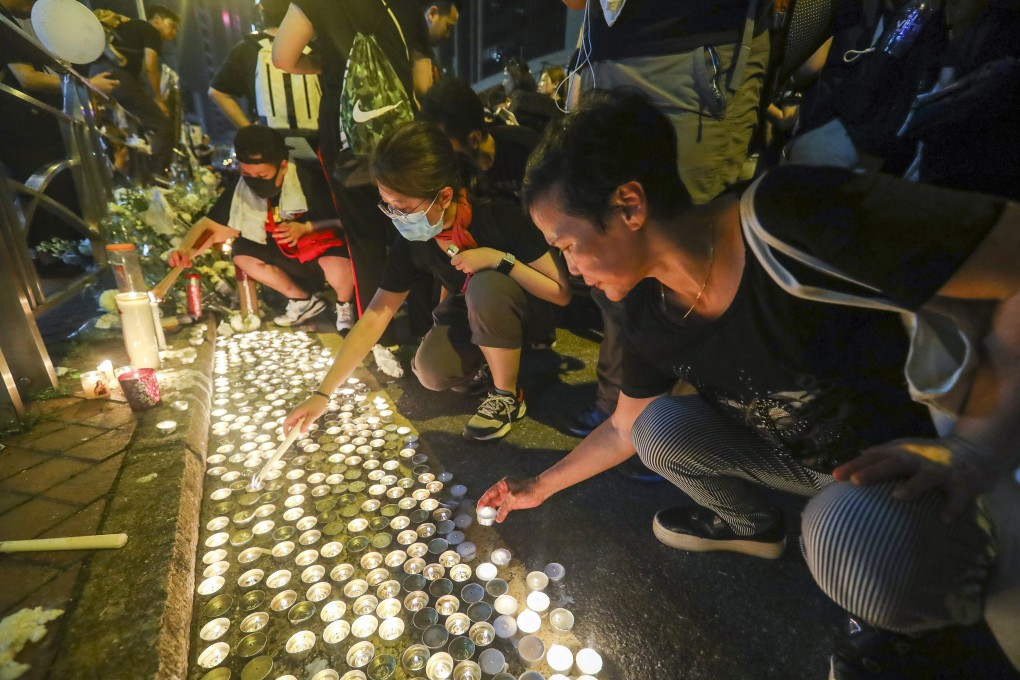 Protesters light candles for a man who fell to his death from Pacific Place mall in Admiralty. Photo: Edmond So