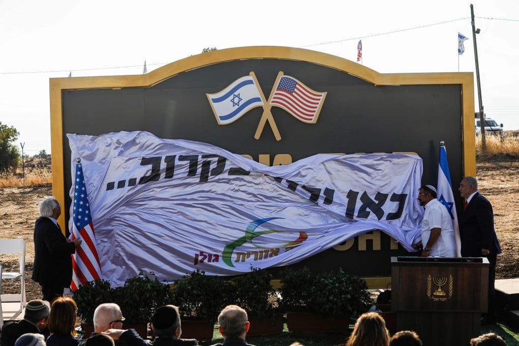 Israeli Prime Minister Benjamin Netanyahu and US Ambassador to Israel David Friedman applaud after unveiling the sign for the new settlement of ‘Ramat Trump’, or ‘Trump Heights’, on Sunday. Photo: AFP