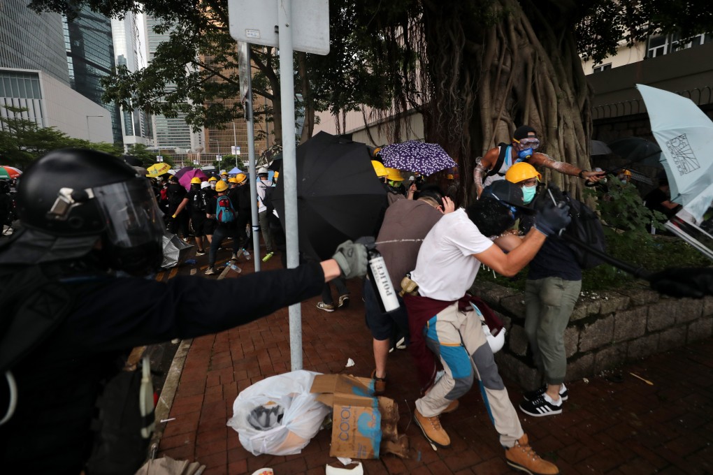 Officers and protesters clash during demonstrations against Hong Kong’s controversial extradition legislation, with police now rolling back on the use of the term ‘riot’. Photo: Sam Tsang