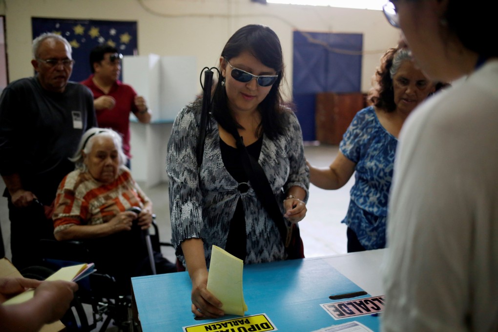 A blind woman votes during the general elections in Guatemala City on Sunday. Photo: EPA-EFE