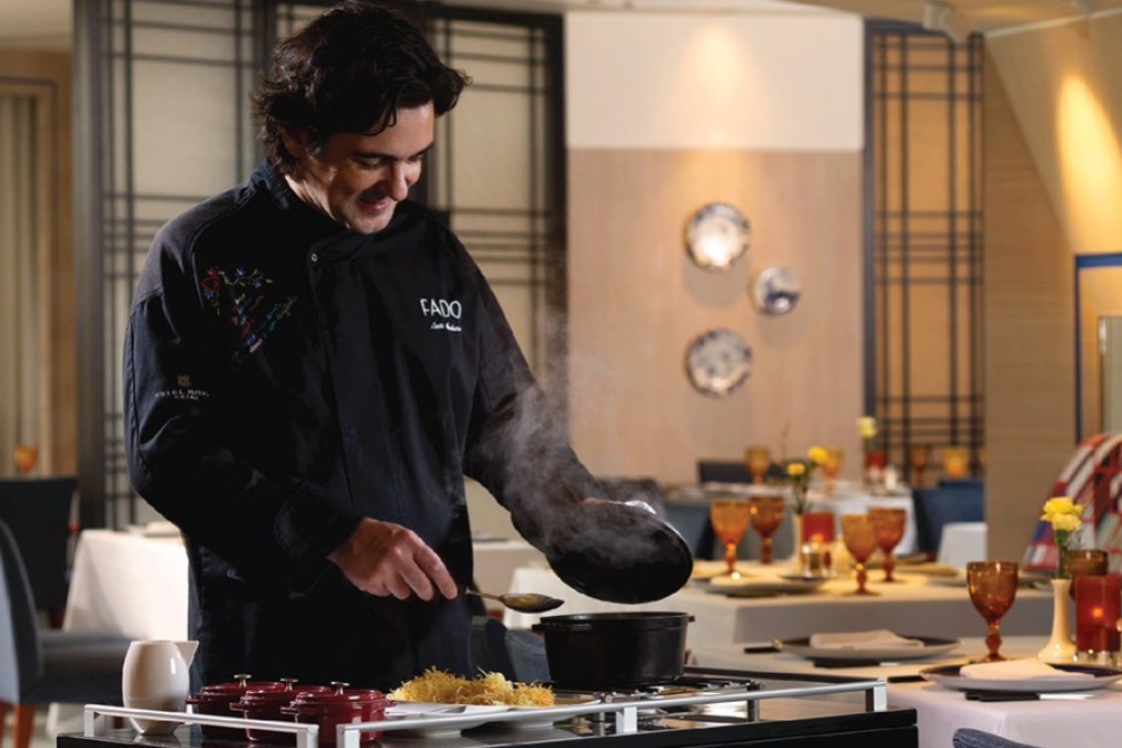 Chef Luís Américo prepares Bacalhau à Brás tableside at Fado.