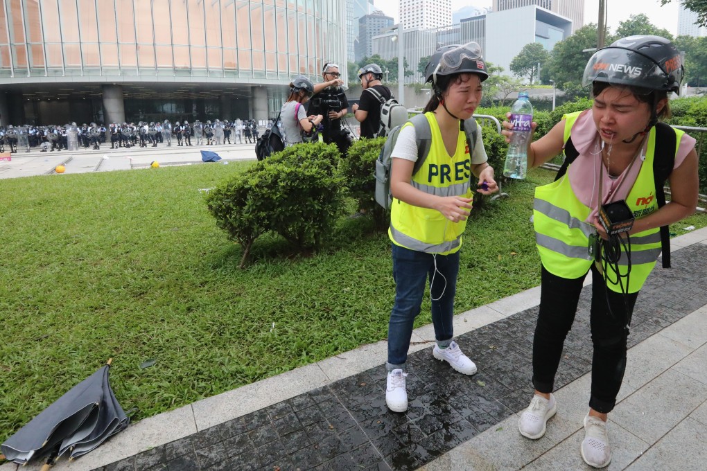 Members of the press suffer from the effects of tear gas fired by police during demonstrations on Wednesday. Photo: Felix Wong