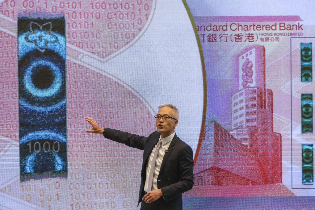 Deputy chief executive of the Hong Kong Monetary Authority Howard Lee Tat-chi explains the features of new Hong Kong banknotes at Two International Finance Centre, in Central on July 24. Photo: Sam Tsang