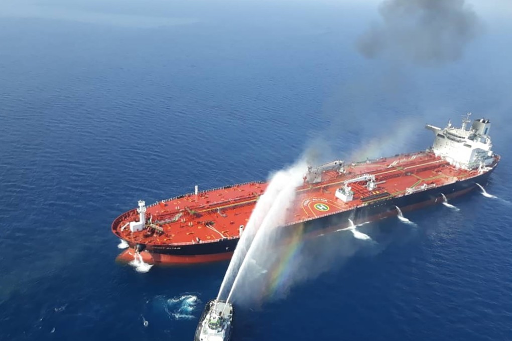 A picture obtained from Iranian news agency Tasnim on June 13 reportedly shows an Iranian navy boat trying to control a tanker fire. Photo: AFP