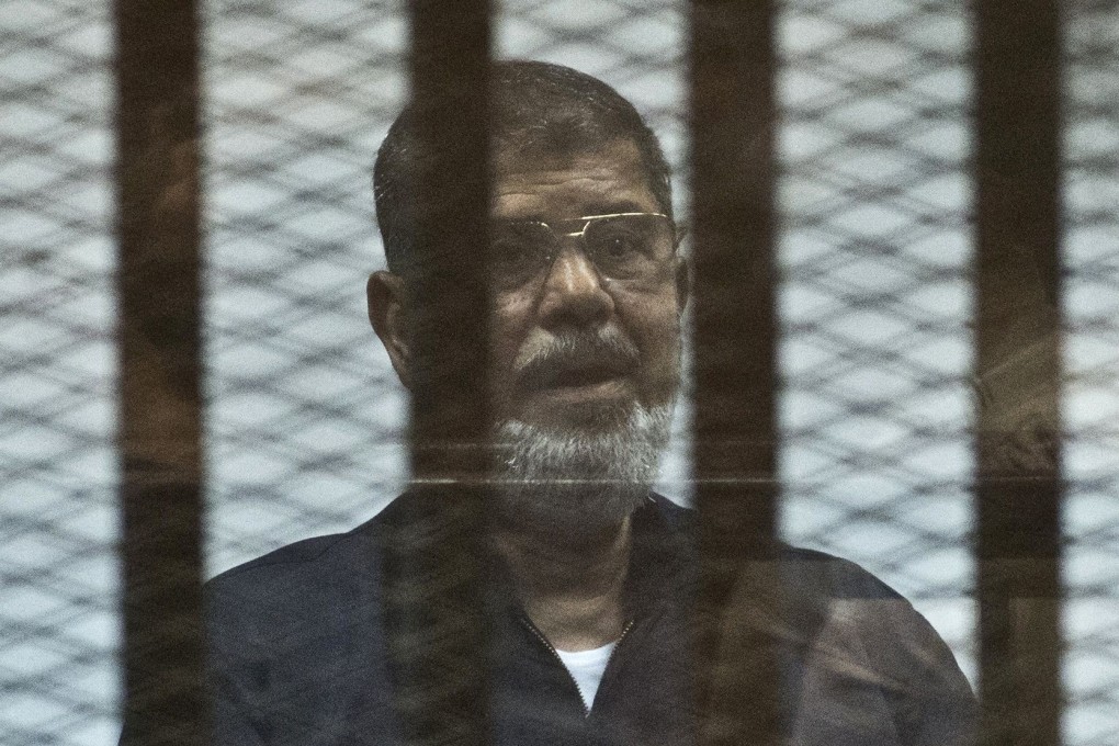 Egypt's ousted president Mohammed Mursi behind bars during a trial in 2015. File photo: AFP