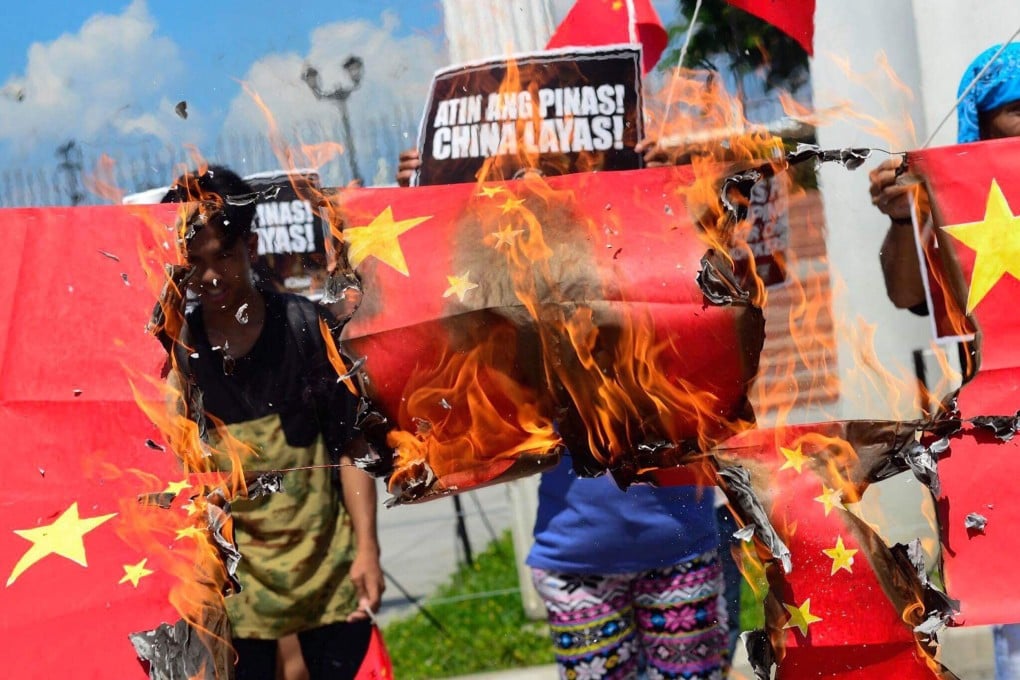 Protesters in Manila burn Chinese flags made of paper. Photo: Handout