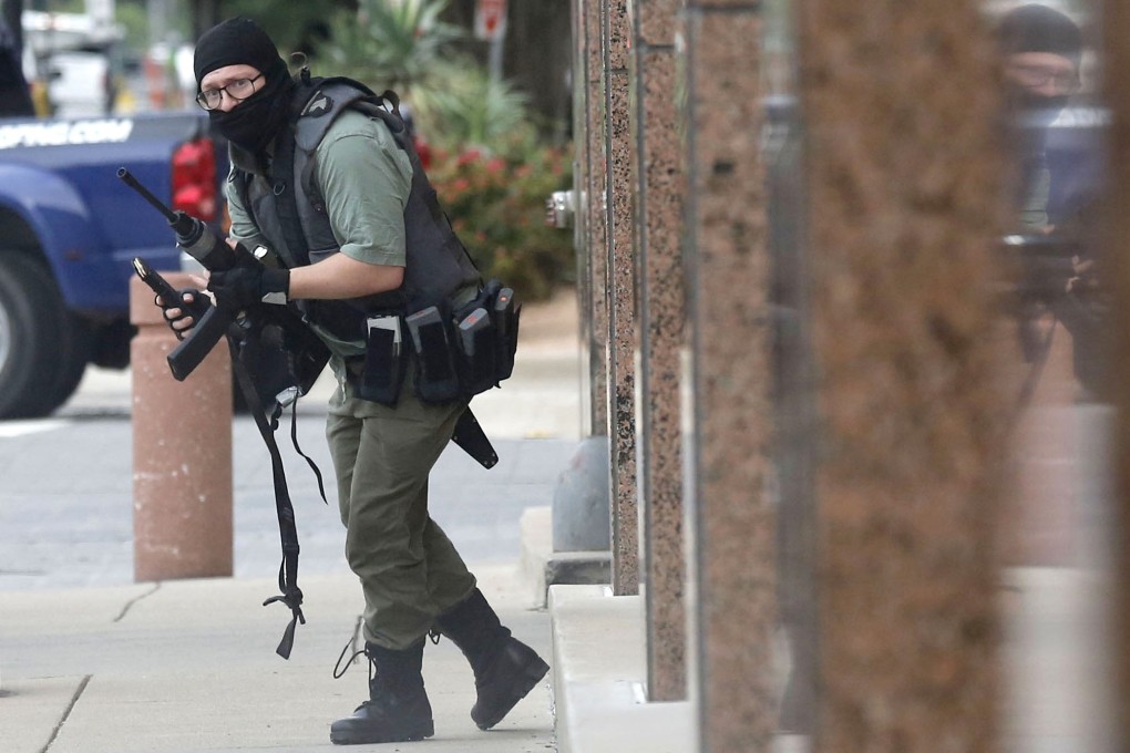 Photojournalist Tom Fox captured this image before running behind a column. Fox’s first instinct when he saw the gunman had been to reach for his camera. Photo: Tom Fox