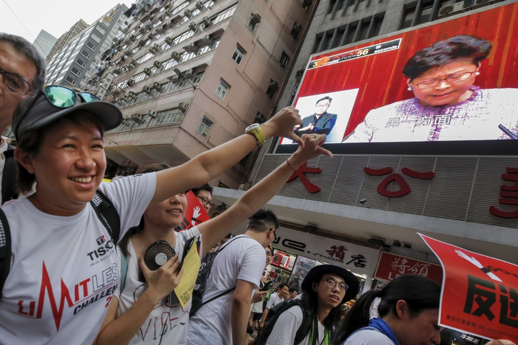Hongkongers express their disapproval of Chief Executive Carrie Lam during protests against the proposed amendments to the extradition law, on June 9. Photo: AP