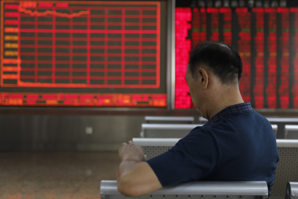 A Chinese investor sits in front of an electronic board showing stock index information at a securities brokerage house in Beijing on June 19, 2019. Photo: EPA-EFE