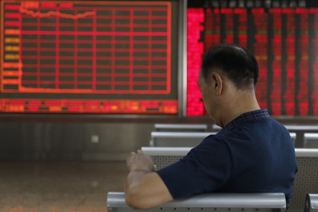 A Chinese investor sits in front of an electronic board showing stock index information at a securities brokerage house in Beijing on June 19, 2019. Photo: EPA-EFE