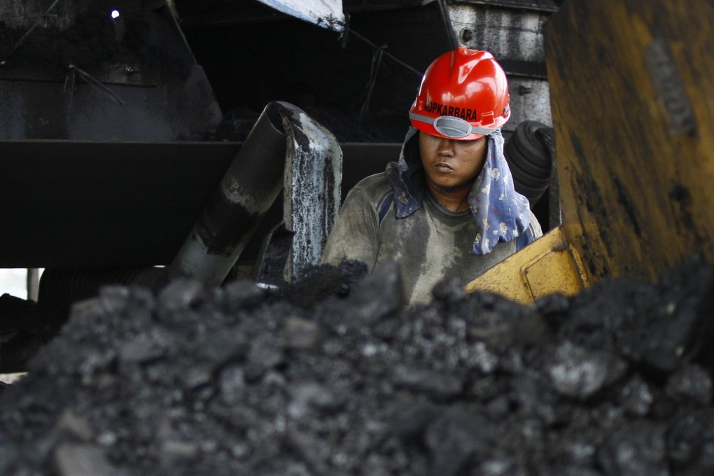 A miner at the Tarahan coal port in Lampung province, Indonesia. The US-China trade war could hit Indonesia’s raw goods exports. Photo: Reuters