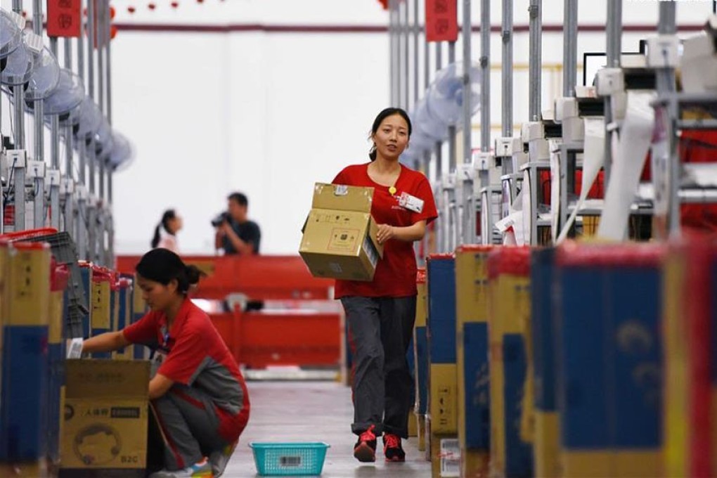 Workers at a JD.com distribution centre process goods set for delivery during the 618 shopping festival. Photo: Xinhua
