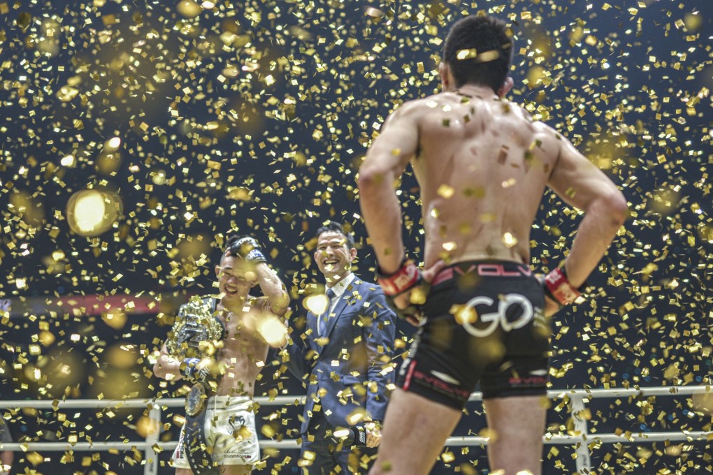 Shinya Aoki looks on as Christian Lee celebrates his lightweight title victory in Singapore. Photos: One Championship