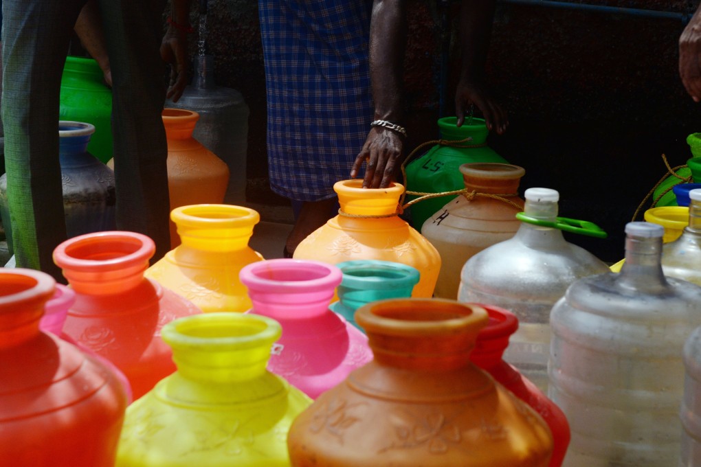 Plastic pots filled with drinking water at a distribution point in Chennai. Photo: AFP