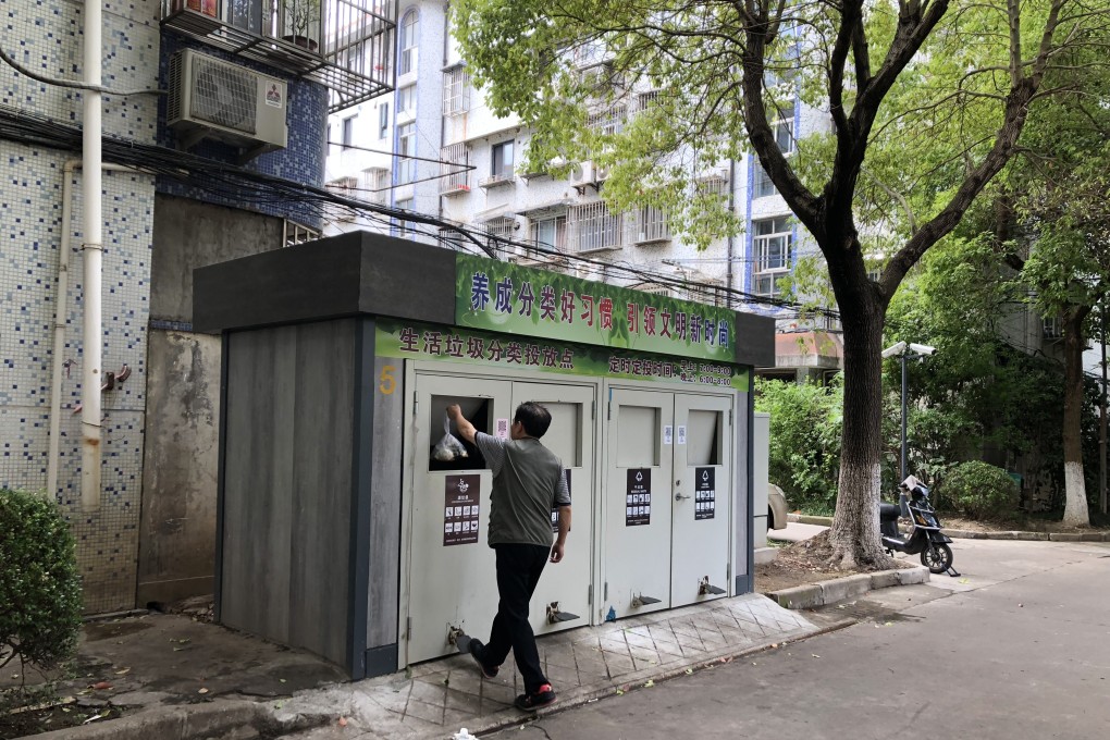 A man places rubbish into one of the new separated bins in Shanghai. Photo: Alice Yan