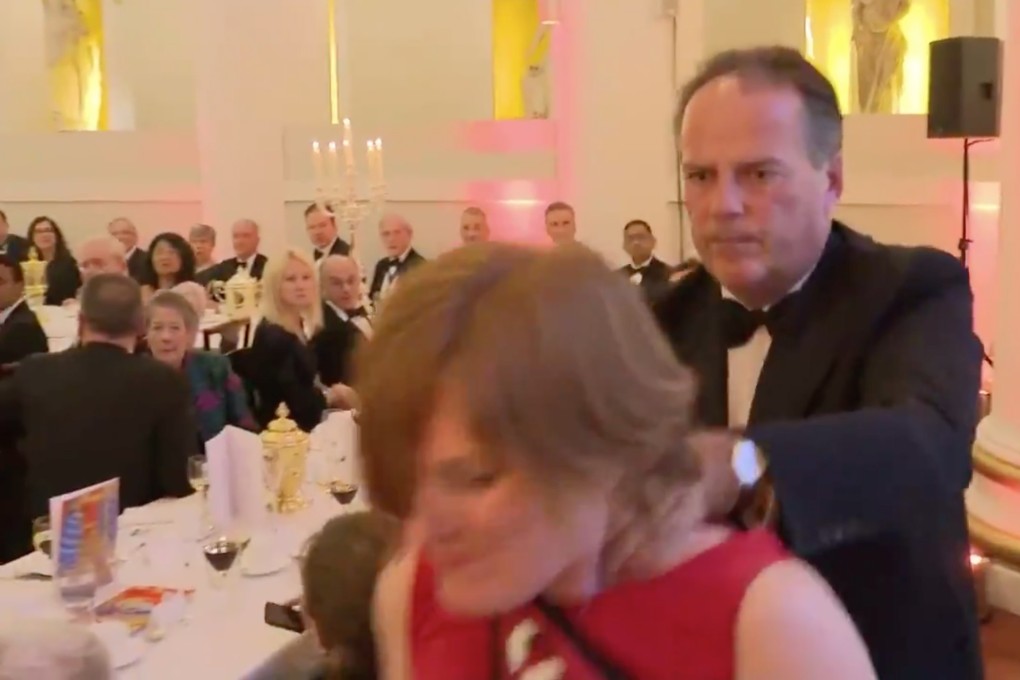 A screen shot of a video showing Britain’s Minister of State for Asia and the Pacific Mark Field grab a Greenpeace protester in London. Photo: ITN