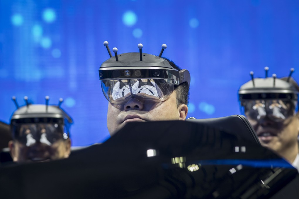 Visitors wear virtual reality headsets to try a driving system in a booth at the CES Asia 2019 trade show in Shanghai on June 11. Photo: Bloomberg