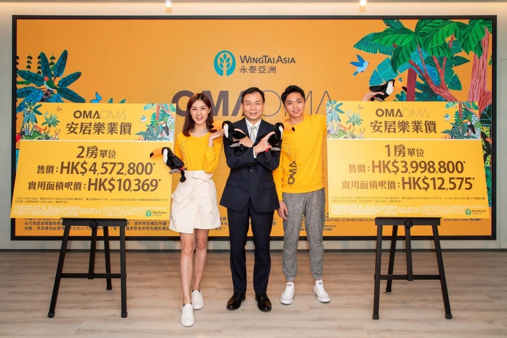 Chung Chi-lam (centre), executive director at Wing Tai Properties, on Thursday announces the launch of the OMA OMA residential development in Tuen Mun. Photo: Handout