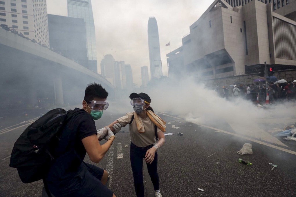 Young Hongkongers flee a cloud of tear gas on Harcourt Road in Admiralty, during protests against the extradition bill on June 12. Traumatic scenes can impact the mental well-being of those who see them in the news, not just those who experience them directly. Photo: Sam Tsang